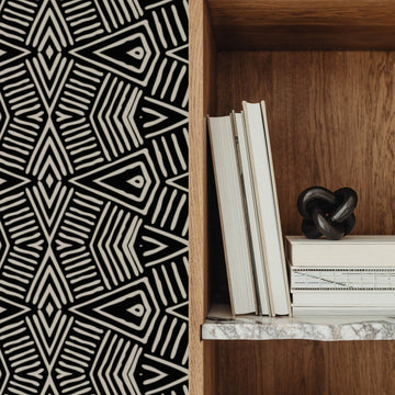 luxurious interior with brown furniture and black and white tribal style wallpaper