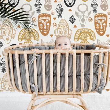 tribal mask pattern wallpaper in nursery interior