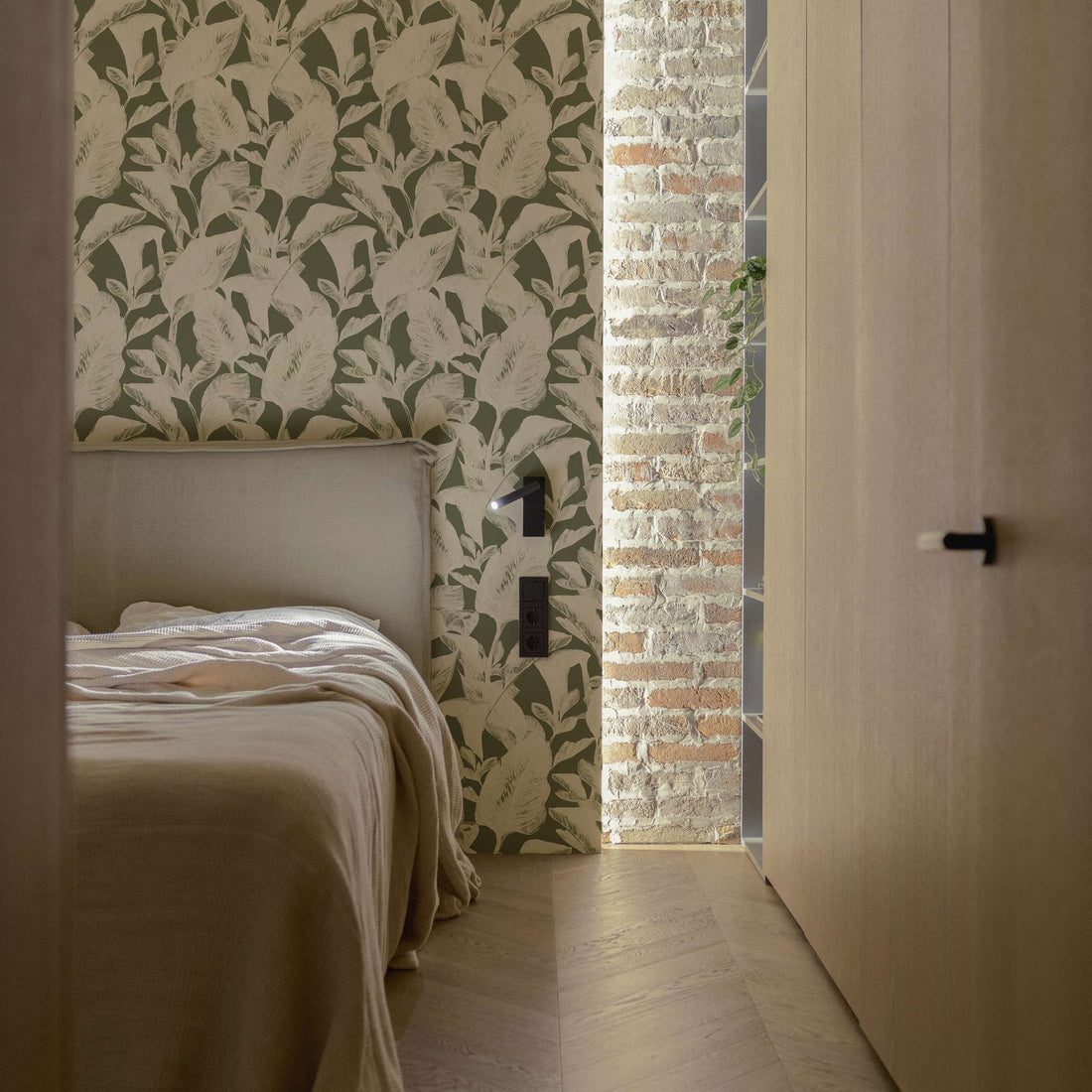neutral bedroom interior design with green leaf print accent wall