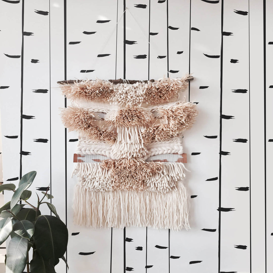Modern birch tree wallpaper with beautiful blush pink wall hanging in girl's bedroom interior