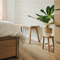light beige bohemian bedroom interior with chevron pattern wallpaper