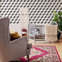 eclectic nursery interior with geometric black and white cube design wallpaper