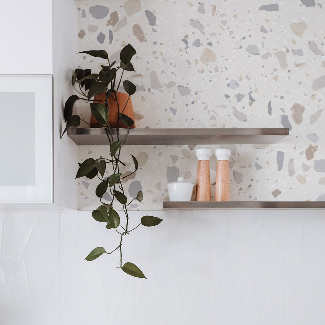 Neutral terrazzo design removable wallpaper in white bathroom interior