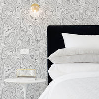 modern art deco parisian bedroom with marble inspired pattern wallpaper