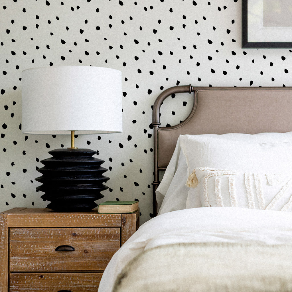 Mid century modern bedroom interior with boho style bedding and speckled removable wallpaper