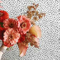 Grey animal print removable wallpaper as a backdrop for flower arrangement photography