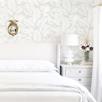 Light green palm leaves removable wallpaper in white bedroom interior
