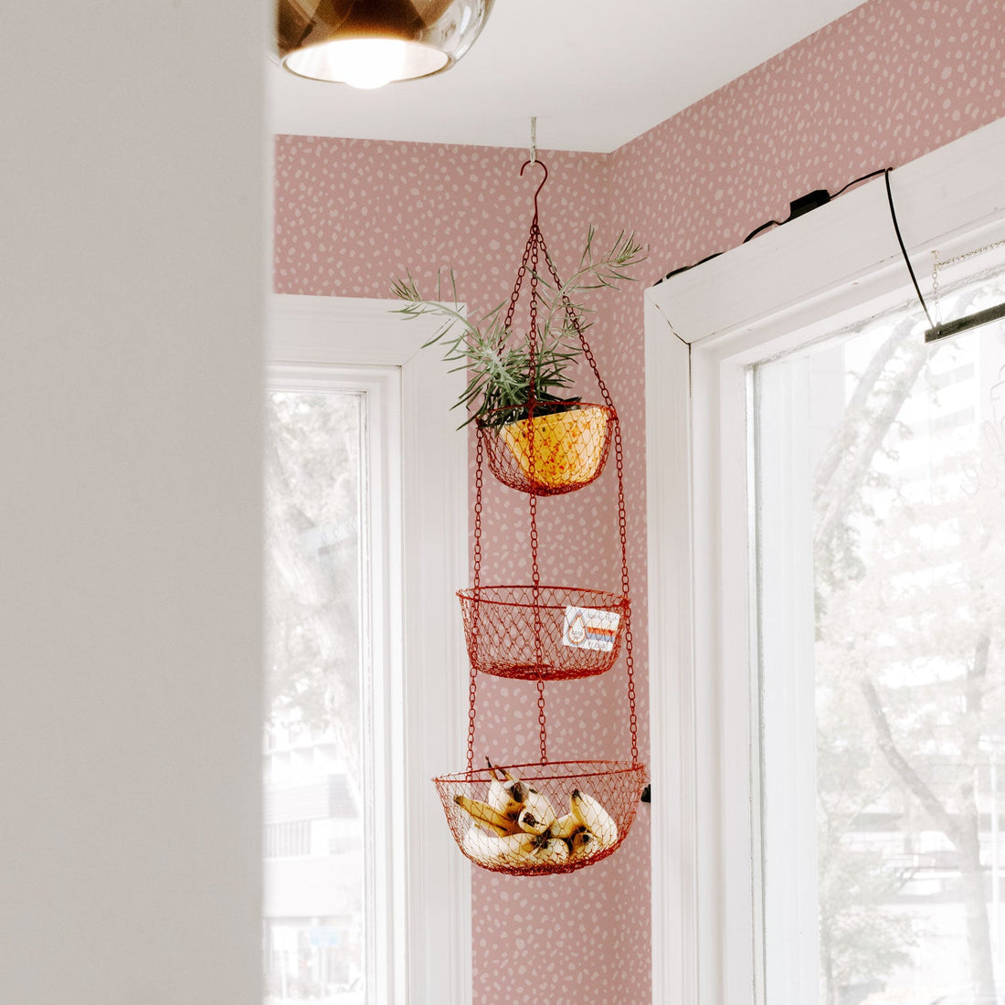 Pale pink dalmatian print removable wallpaper in white kitchen interior
