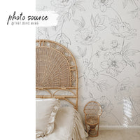 delicate black and white floral print wallpaper with bohemian rattan bed