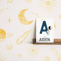yellow space inspired wallpaper for little boys bedroom interior
